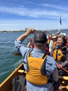 Métis Tours Guide Dustin Hoogsteen is holding up a sea lamprey prop during a walking and paddling tour on Saint Marys River in Sault Ste Marie